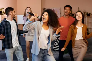 Two friends singing a duet with LaSing Karaoke at a house party